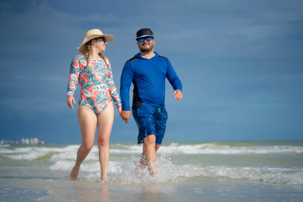 istock Young couple walking on the beach 1262563239