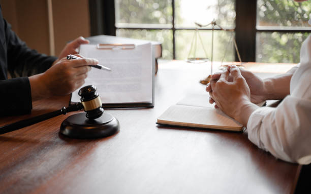 istock lawyer consulting with client discussing about contract. 1262564100