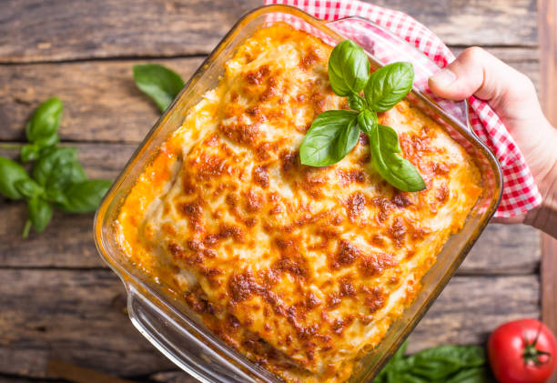 istock Traditional italian lasagna with vegetables, basil, minced beef meat, tomato and cheese on wooden  background. 1262566614