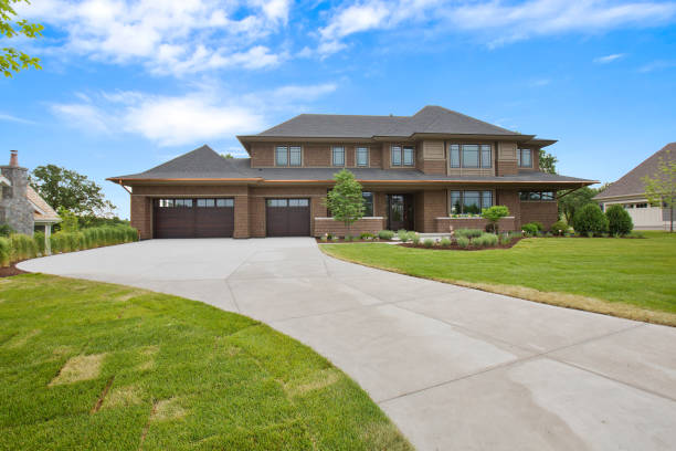 istock Brown traditional home with long winding driveway 1262566654