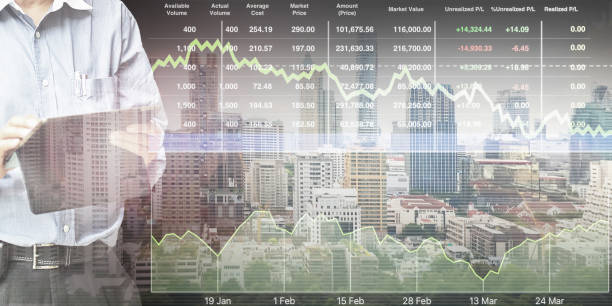 Businessman  standing and operate tablet to control and connect big data of real estate sector stock market index with chart and graph background. stock photo