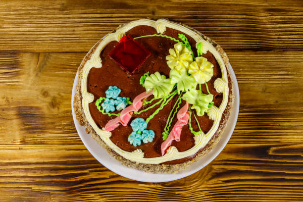 istock Kiev cake with cream, nuts and meringue on wooden table. Top view 1262572376