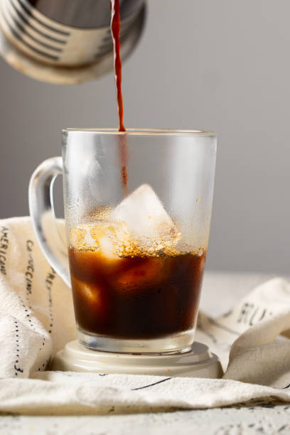 istock Coffee pouring into the glass cup with ice. Ice coffee concept. 1262572519