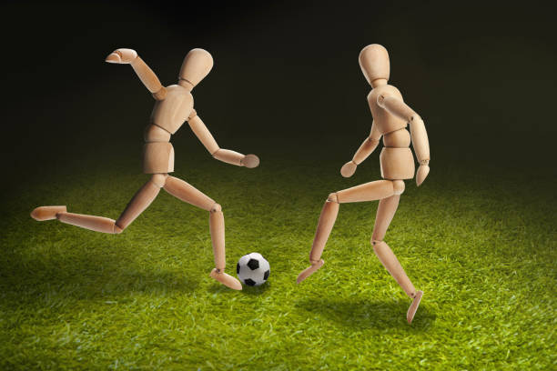 istock Wooden dummies models playing soccer 1262573323