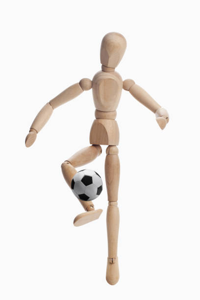 istock Wooden dummy model playing soccer 1262573331