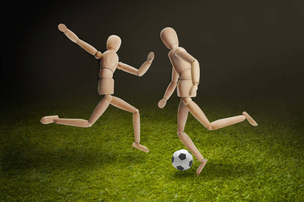 istock Wooden dummies models playing soccer 1262573591