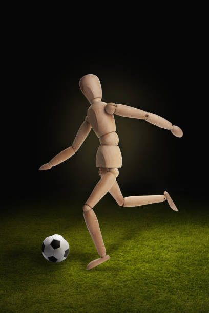 istock Wooden dummy model playing soccer 1262574219