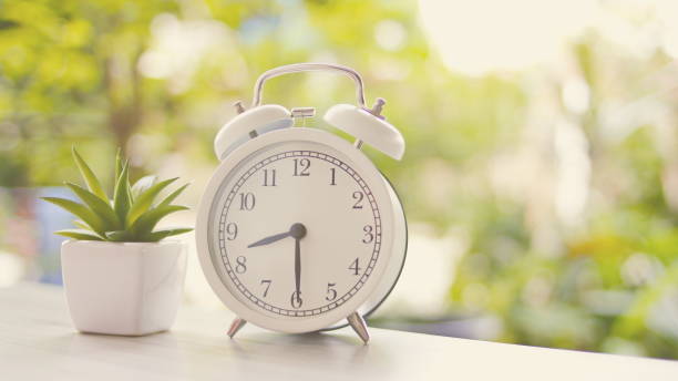 istock An alarm clock placed on a wooden table 1262574591