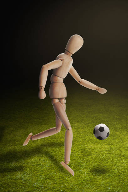 istock Wooden dummy model playing soccer 1262575389