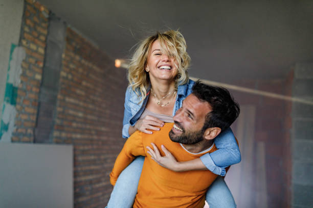 istock Happy couple having fun while piggybacking during home renovation process. 1262575409
