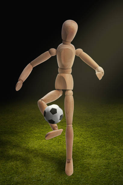 Wooden dummy model playing soccer