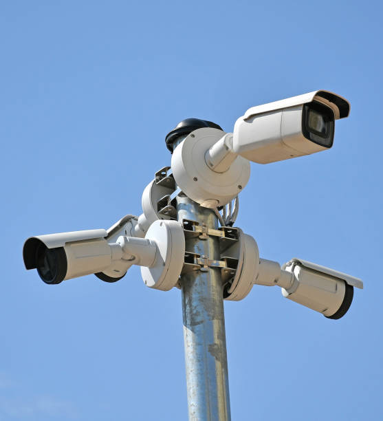 istock Security cameras on a metal pole against sky 1262575579