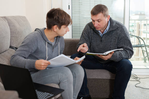 istock Father helping son to do homework 1262576472