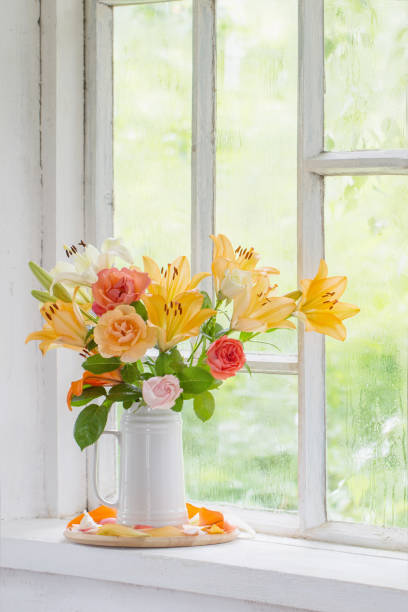 istock summer flowers in vase on background window with drops water 1262576548