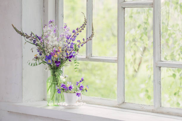 istock wild flowers in vase on white windowsill 1262578246