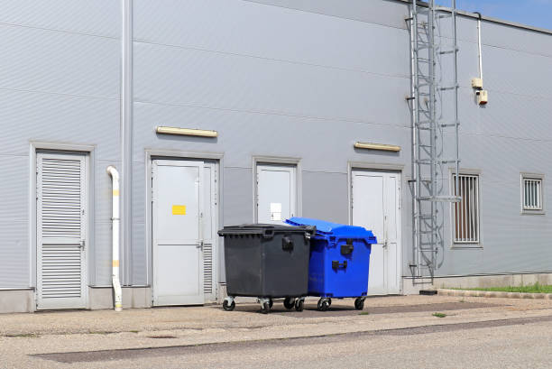 istock Back side of the warehouse building with garbage cans 1262578958