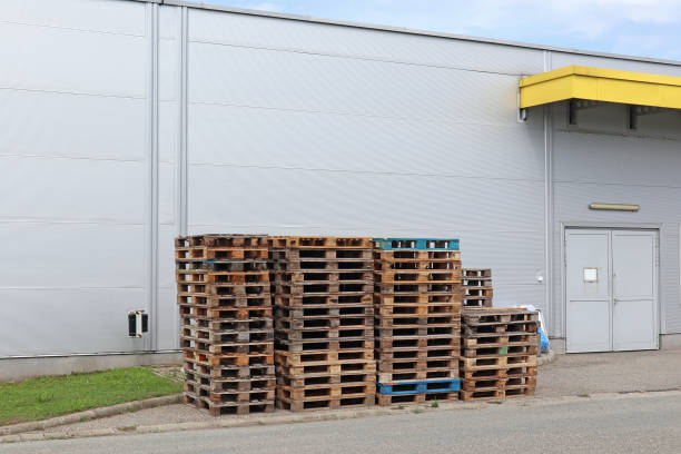 istock Pallets next to the warehouse building 1262579020