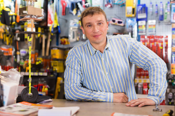 istock Nice seller man in store is trading tools 1262581274
