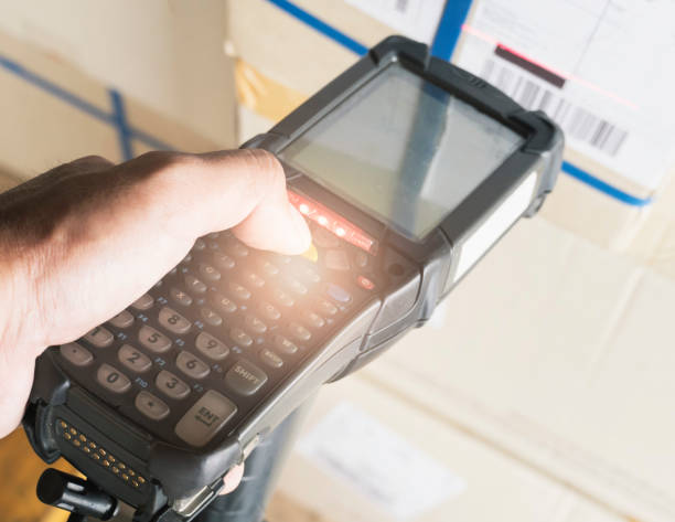 istock Closeup worker scanning barcode scanner with shipment product. Computer equipment for warehouse inventory management. 1262581904