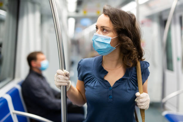 istock Brunette in medical mask in subway car 1262582093