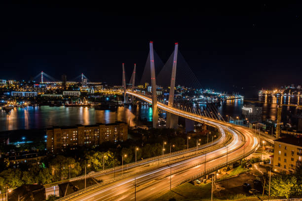 Panorama of night Vladivostok. The bridge through a bay Golden Horn. stock photo