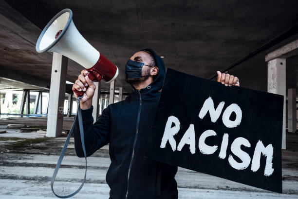 Stop racism Afroamerican man wearing hoodie holds banner. Anti-racism concept. i cant breathe photos stock pictures, royalty-free photos & images