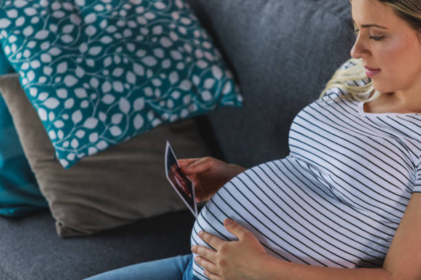 istock Anticipating baby while looking at it's ultrasound image 1262584857