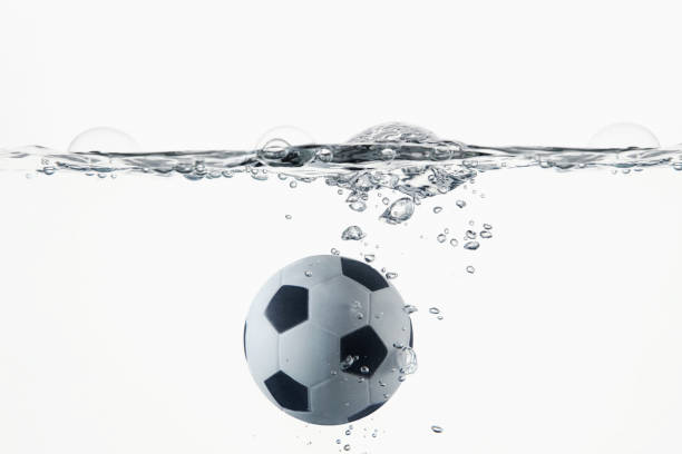 istock Soccer ball splashing into water 1262584908