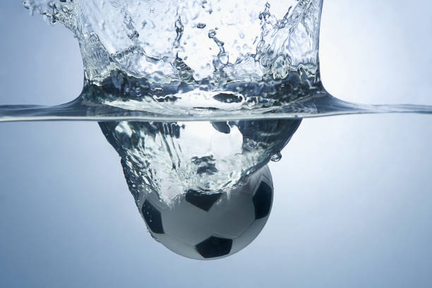 istock Soccer ball splashing into water 1262585113