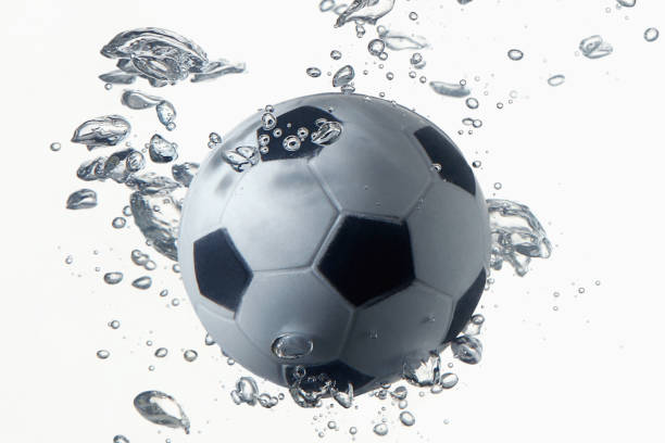 istock Soccer ball splashing into water 1262585434