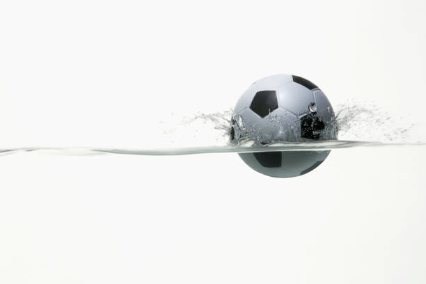istock Soccer ball splashing into water 1262585460