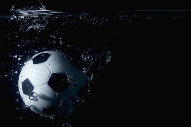 istock Soccer ball splashing into water 1262585591