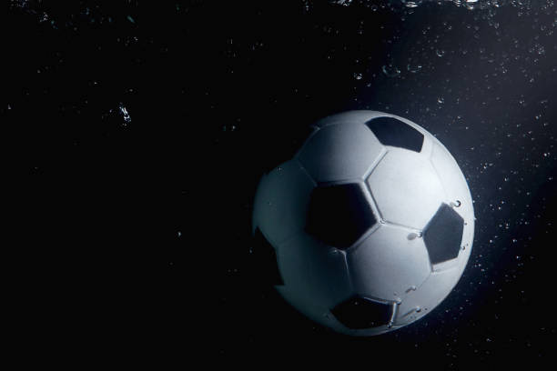 istock Soccer ball splashing into water 1262585798