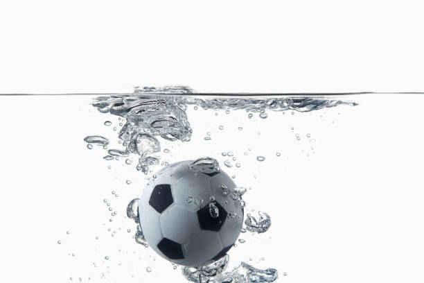 istock Soccer ball splashing into water 1262586936