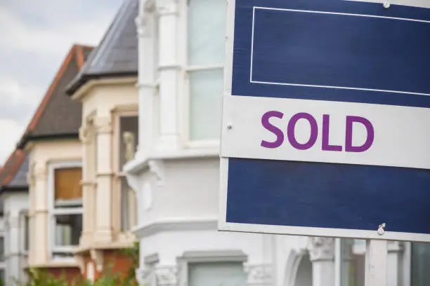 Sold sign displayed outside a terraced house in Harringay Ladder area, London, England