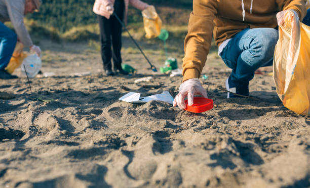 istock Young man cleaning the beach 1262592317