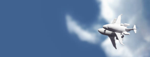 istock A white toy plane stands on a mirror that reflects a blue sky with clouds 1262592545