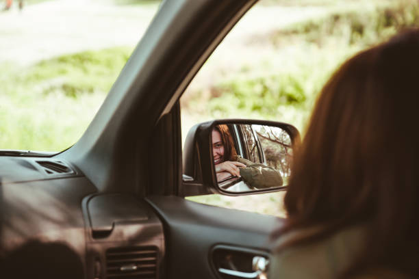 istock reflection on stunning smiling woman in car rear mirror 1262592730