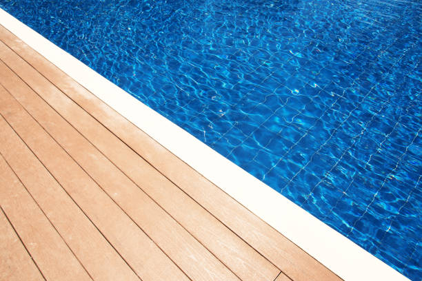 istock Empty wooden balcony terrace beside swimming pool 1262593620