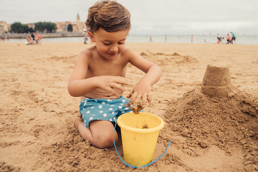 kid playing with sand