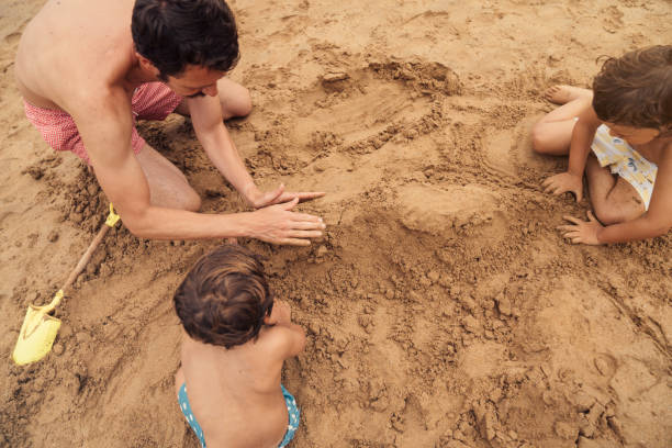 istock Boys playing at the beach 1262593987
