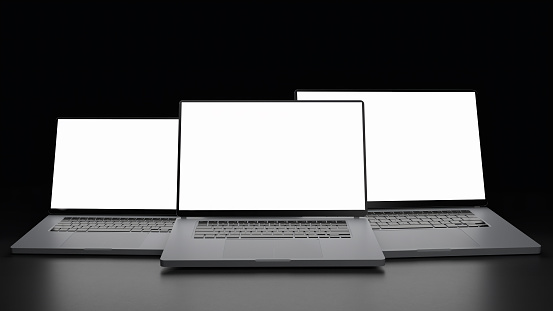 Three laptops in air on black background. Template. White display. Concept mockup