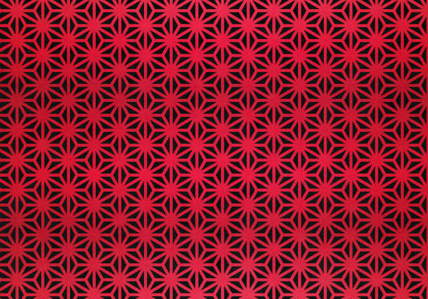 Dark red background from metal foil paper with a pattern of sparkling golden stars, closeup. Texture of wine metalized wrapping holiday paper surface with vignette.