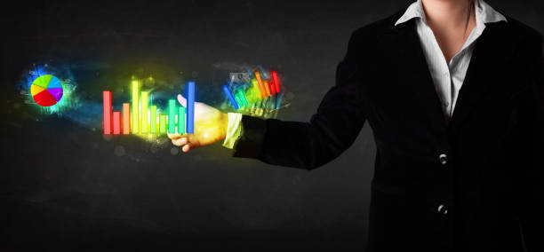 istock Young businesswoman touching colorful modern graph system concept 1262598288