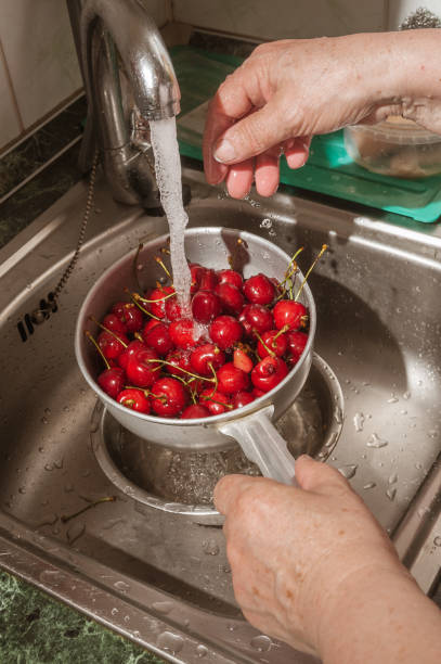 istock red cherry under running water in a colander 1262598580