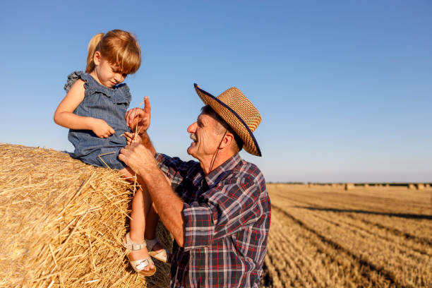 istock Framer having fun with child sitting on the hay 1262600452
