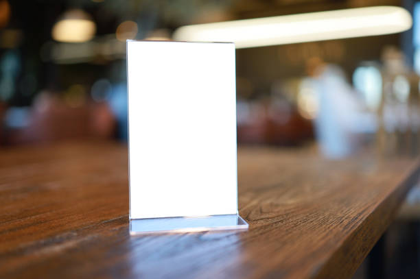 istock Mock up Menu frame standing on wood table in Bar restaurant cafe. space for text. 1262602937