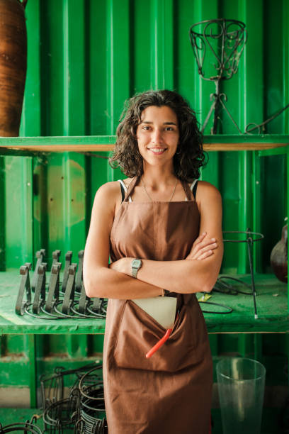 istock Young shop assistant in her ceramic shop surrounded by her products 1262602979