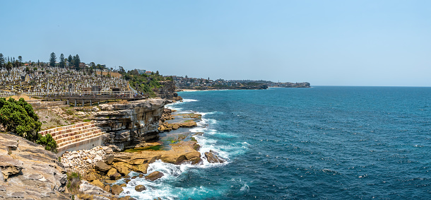 Sydney, Australia - December 28th, 2019: Walking to Waverley Cemetery along the Bondi to Coogee coastal walk. A cliff top coastal walk featuring stunning views, beaches, cliffs, and rock pools.