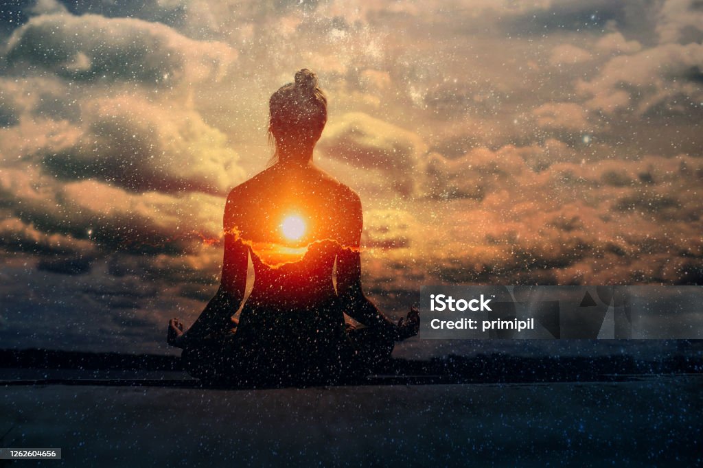 Yoga day concept. Multiple exposure image. Clouds and sun. Pranayama in lotus asana. Yoga day concept. Multiple exposure image. Clouds and sun. Pranayama in lotus asana Zen-like Stock Photo